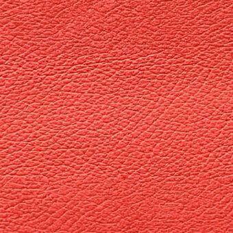 Coral red leather texture with a dense, pebbled grain and matte finish, displaying irregular bumps and creases; egoitaliano sample "nibe" 4497(c).